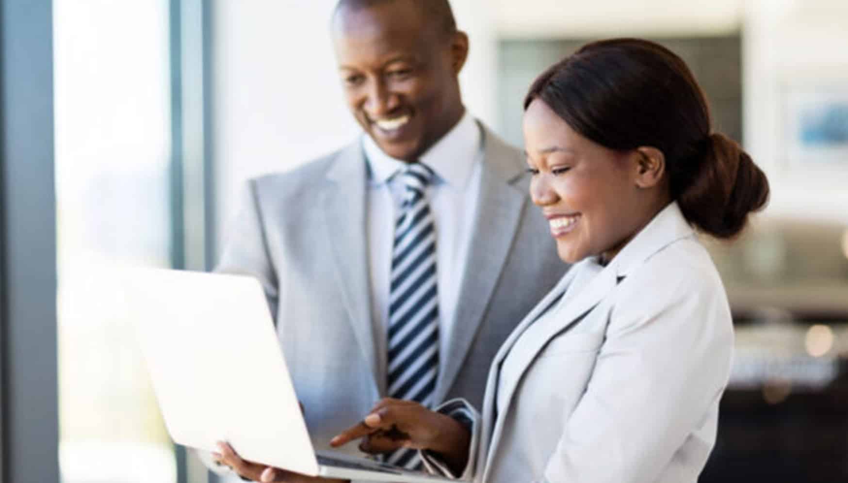 Two people looking at a laptop together